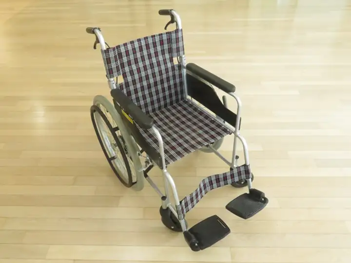 チェック柄の座面を持つ、標準的な折りたたみ式の自走・介助兼用車いす